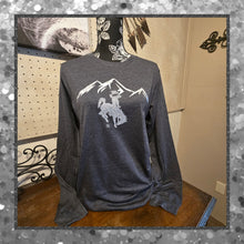 Gray long-sleeve shirt with mountain and horse graphic on a mannequin against a neutral wall.